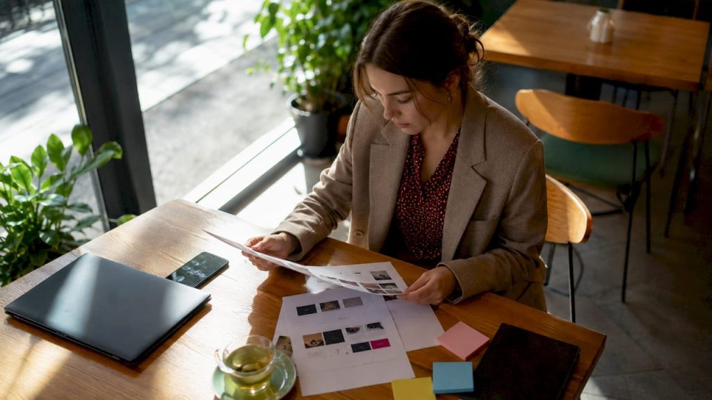 Woman reviewing web agency comparison charts