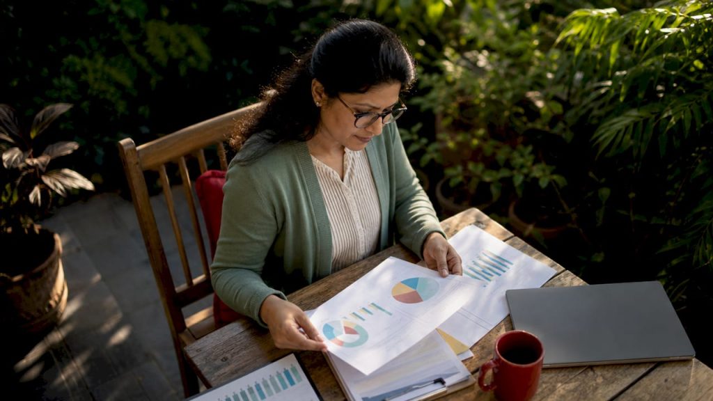 Business owner reviewing printed analytics report